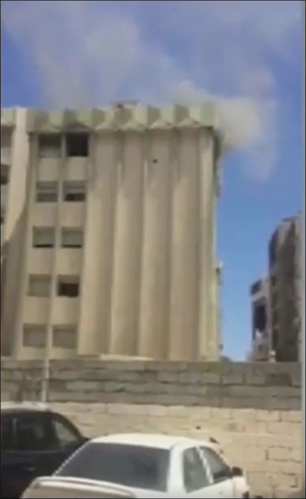 Libya- smoke rising from top floor of Eni HQ in central Tripoli as part of ongoing and large scale militia fighting across the city  