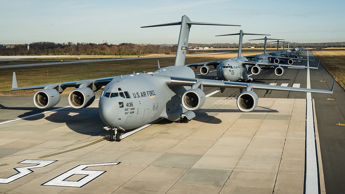 A couple of USAF Boeing C-17A (02-1099, 10-0215) in flight over Western Mediterranean sea southbound